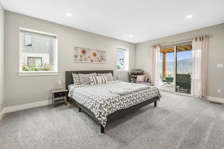 Bedroom featuring light carpet, access to outside, a mountain view, and recessed lighting