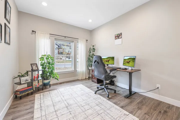 Office space with wood finished floors and recessed lighting