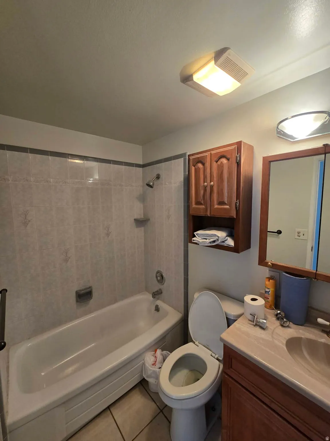 Full bathroom with vanity, shower / bath combination, and light tile patterned floors