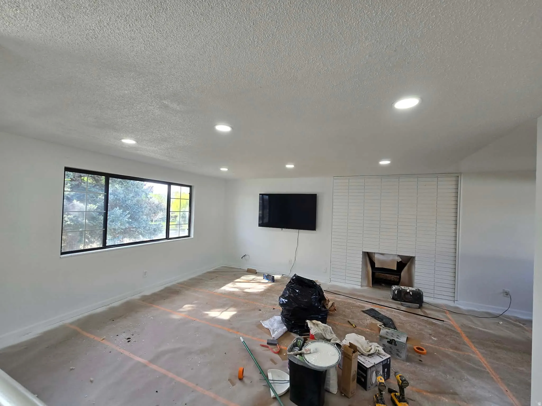 Living room featuring a textured ceiling and recessed lighting