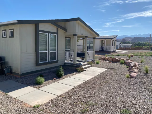View of property exterior featuring a mountain and redrock view with covered porch