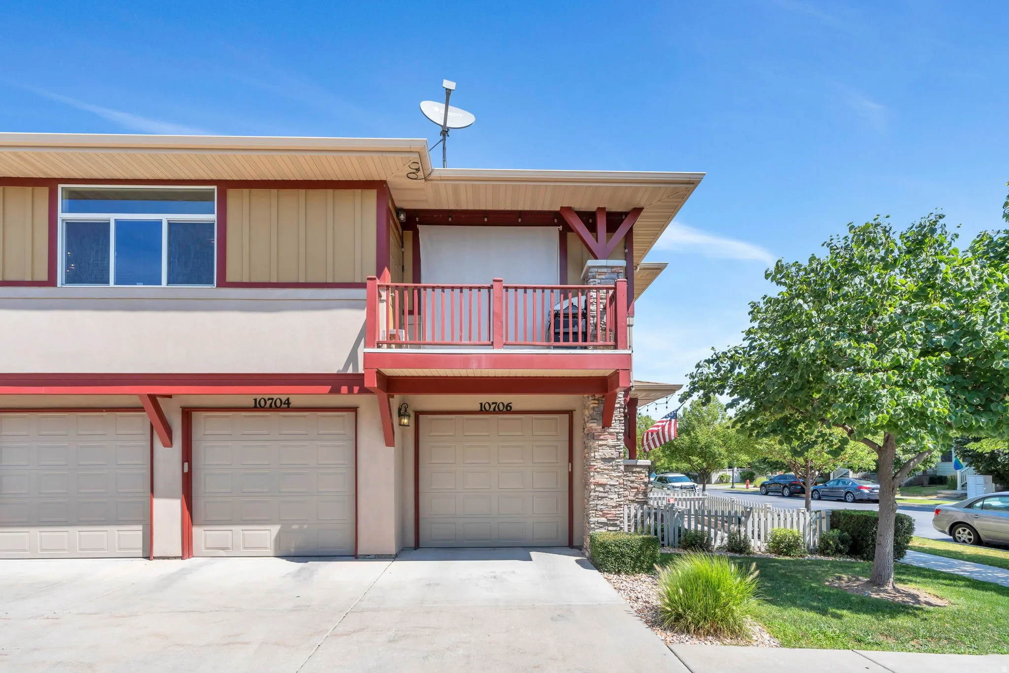 View of front of home featuring a balcony, concrete driveway, an attached garage, and board and batten siding