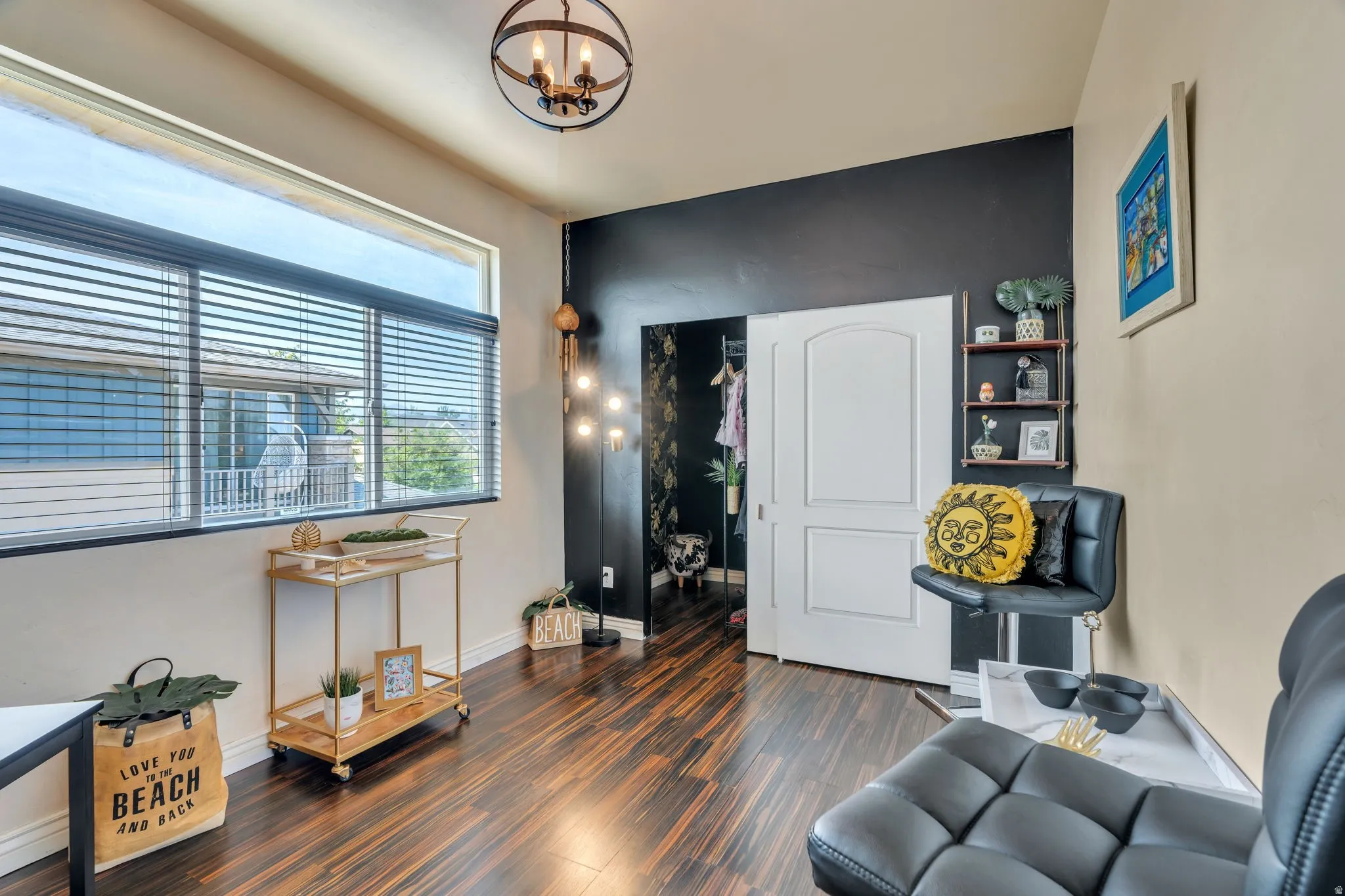 Living area featuring dark wood-type flooring and hanging lights