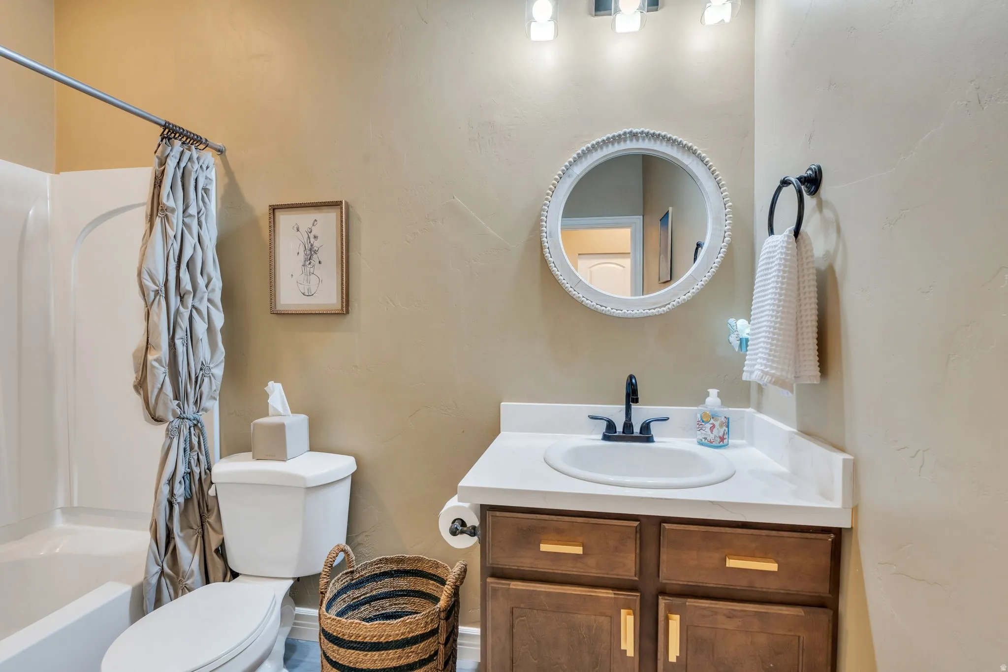 Bathroom featuring vanity and shower / tub combo
