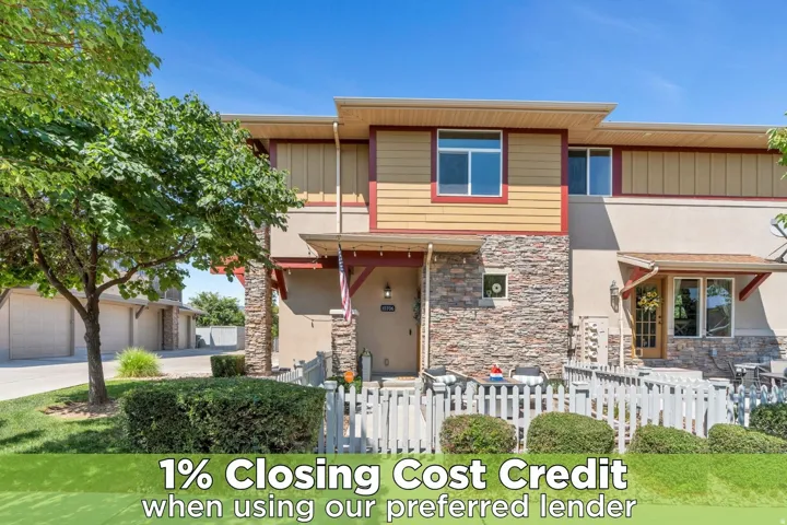 View of front facade with a fenced front yard and stone siding