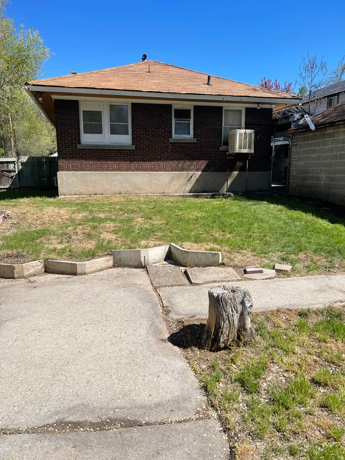 Rear view of house with brick siding and roof with shingles
