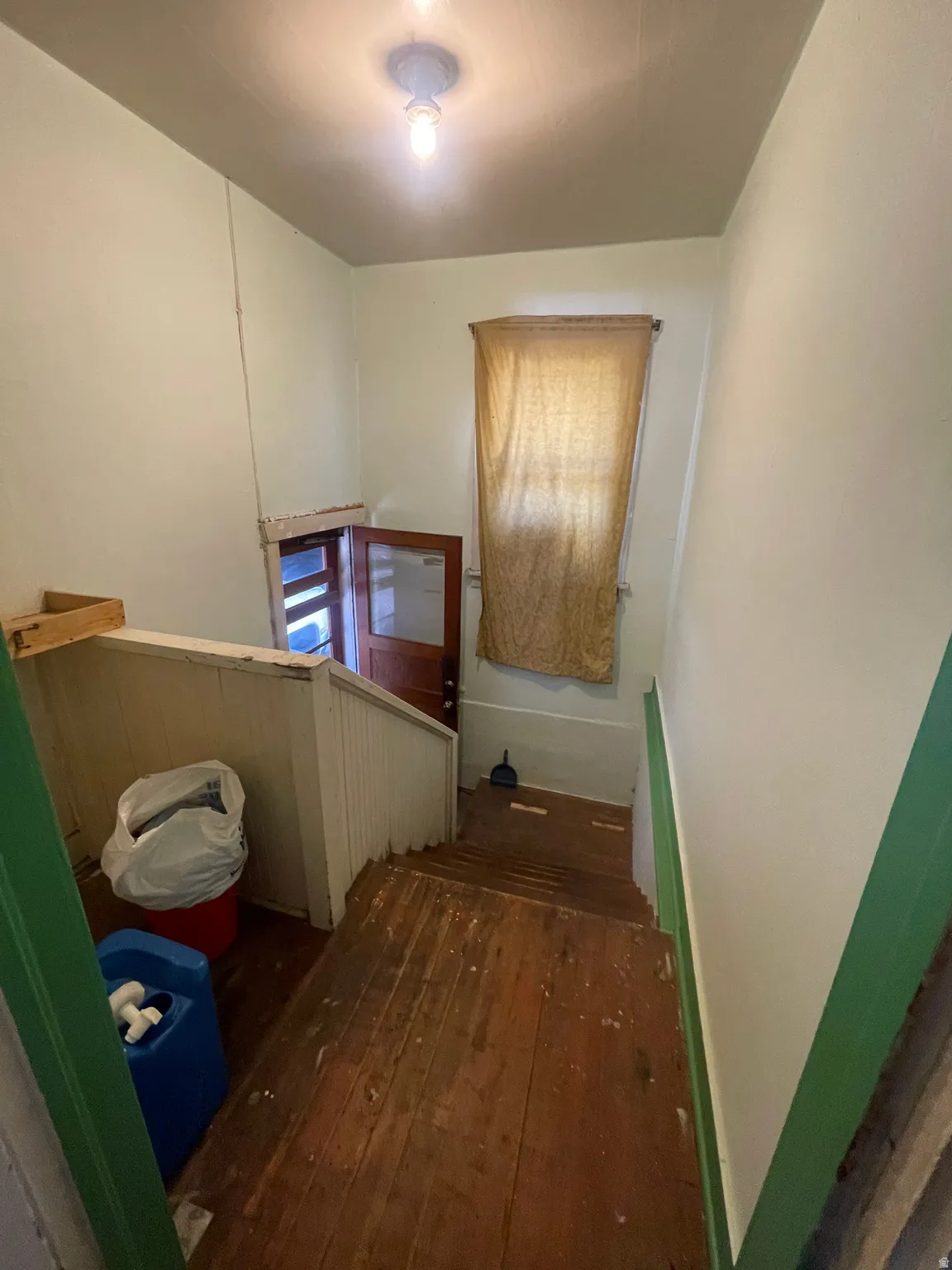 Staircase featuring hardwood / wood-style floors
