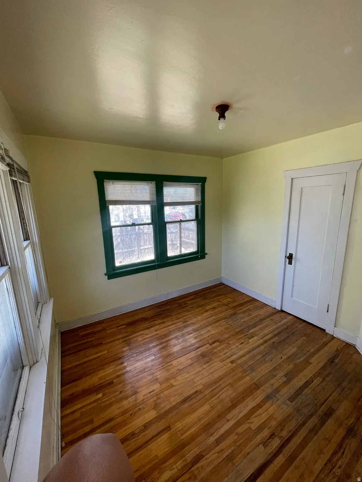Empty room with dark wood finished floors and baseboards