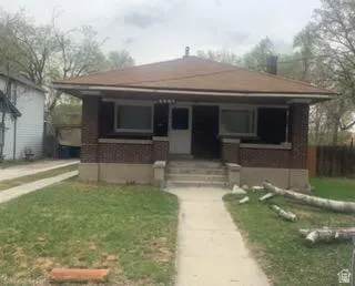 Bungalow-style house with a porch and a front yard