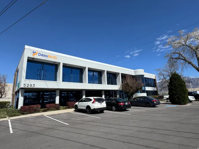 View of building exterior featuring uncovered parking
