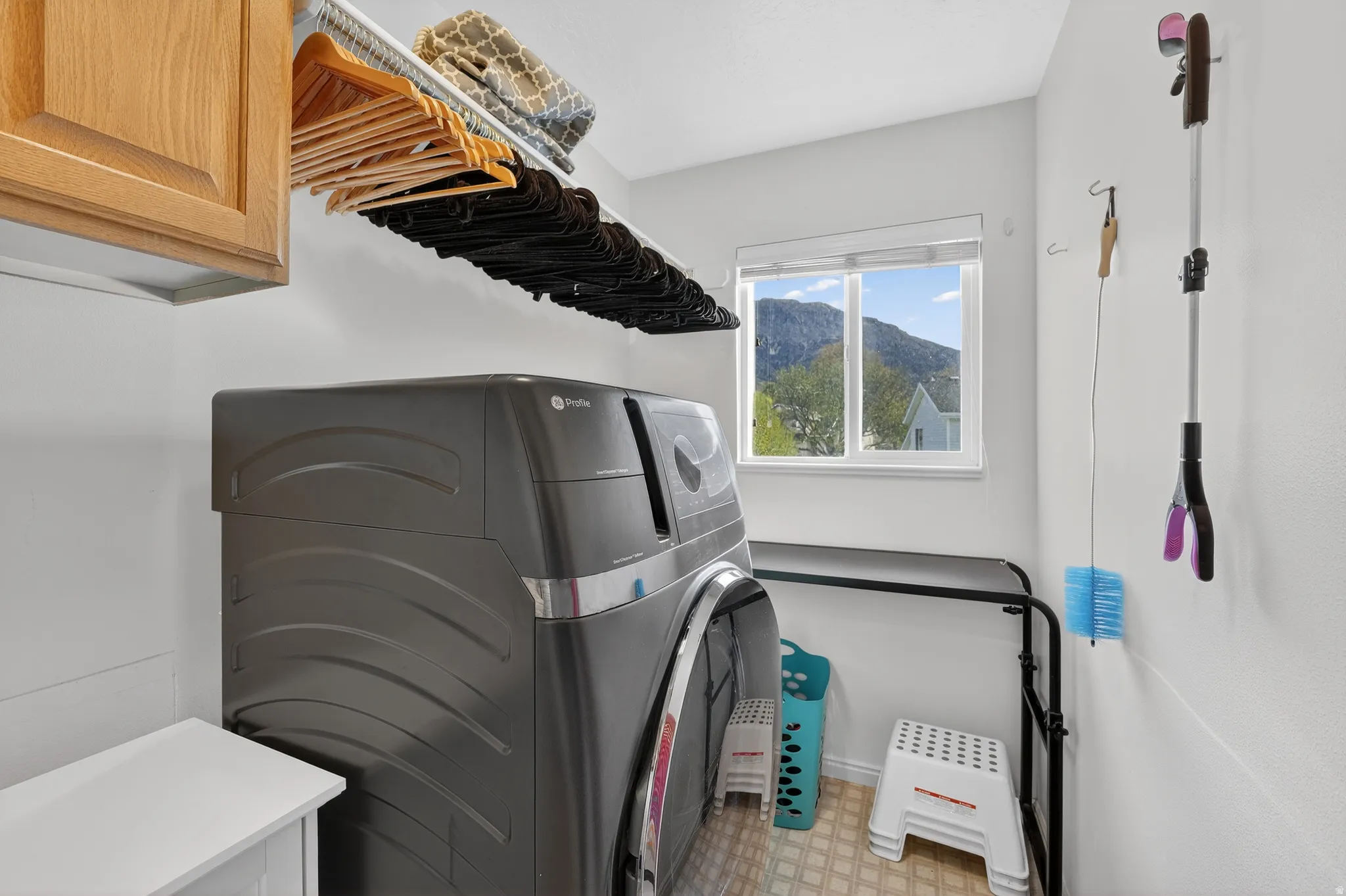 Laundry room featuring washer / dryer, light flooring, and a mountain view