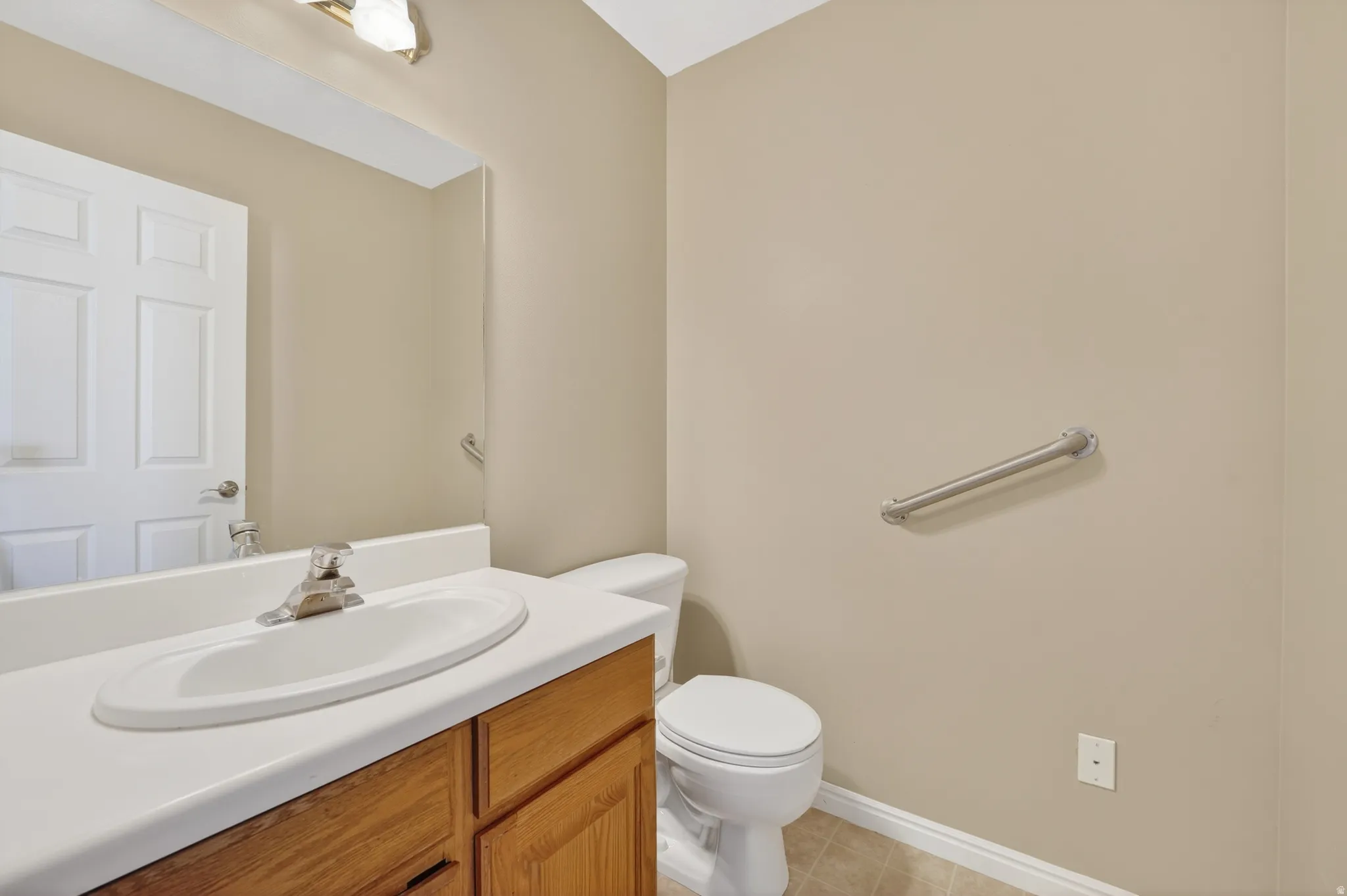 Bathroom with vanity and light tile patterned flooring