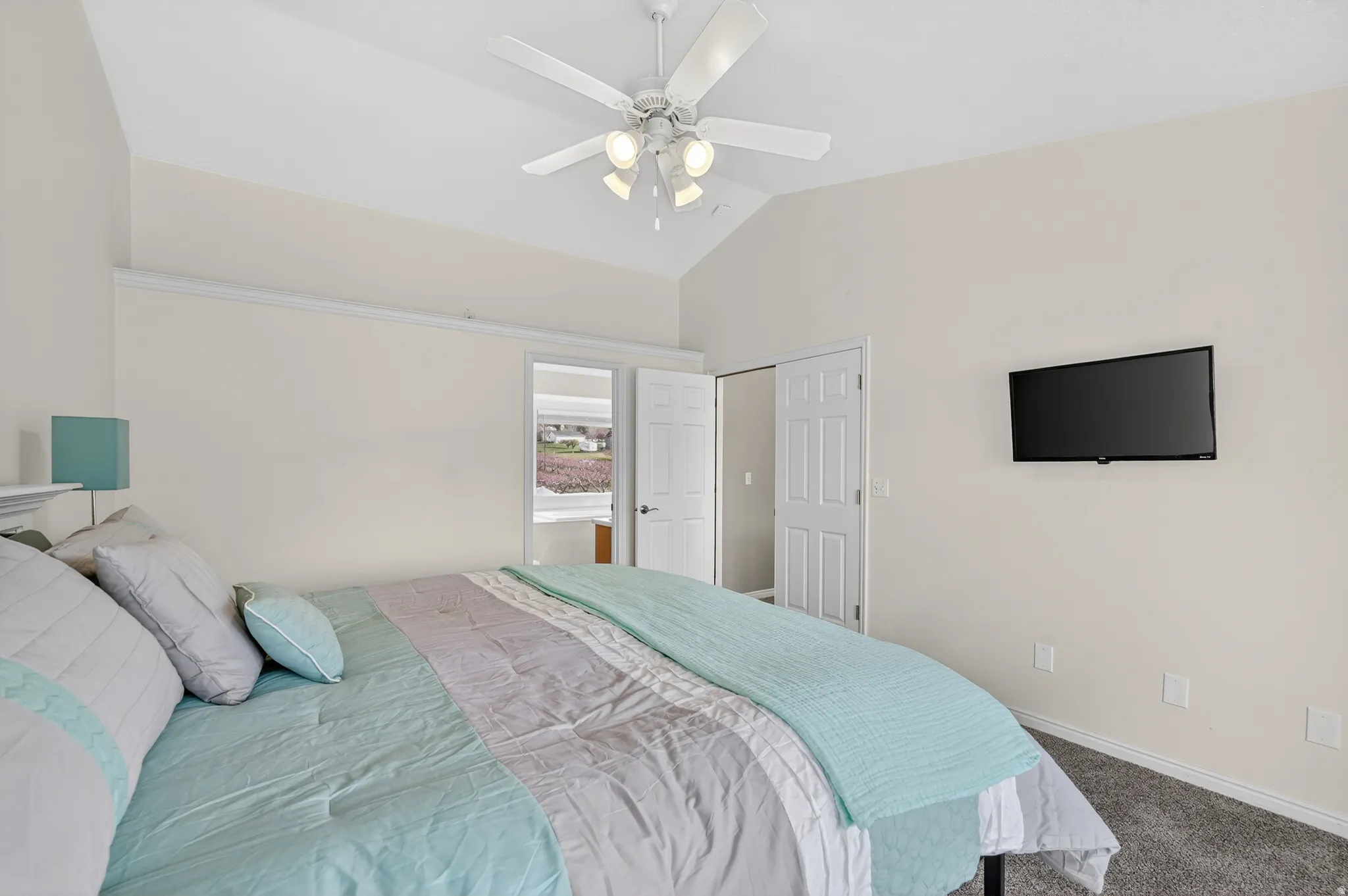 Bedroom featuring lofted ceiling, dark carpet, and a ceiling fan