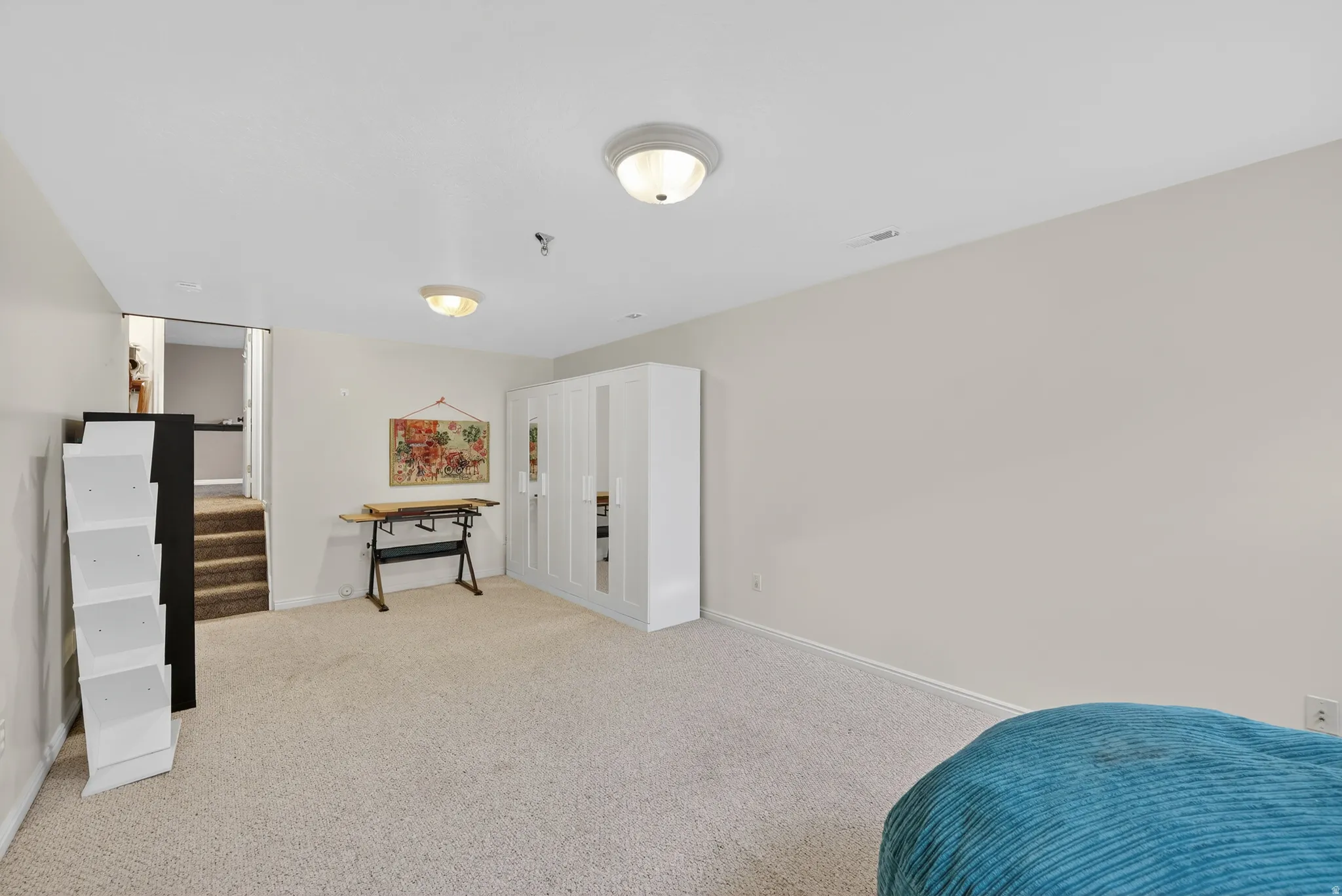 Bedroom featuring light carpet and baseboards