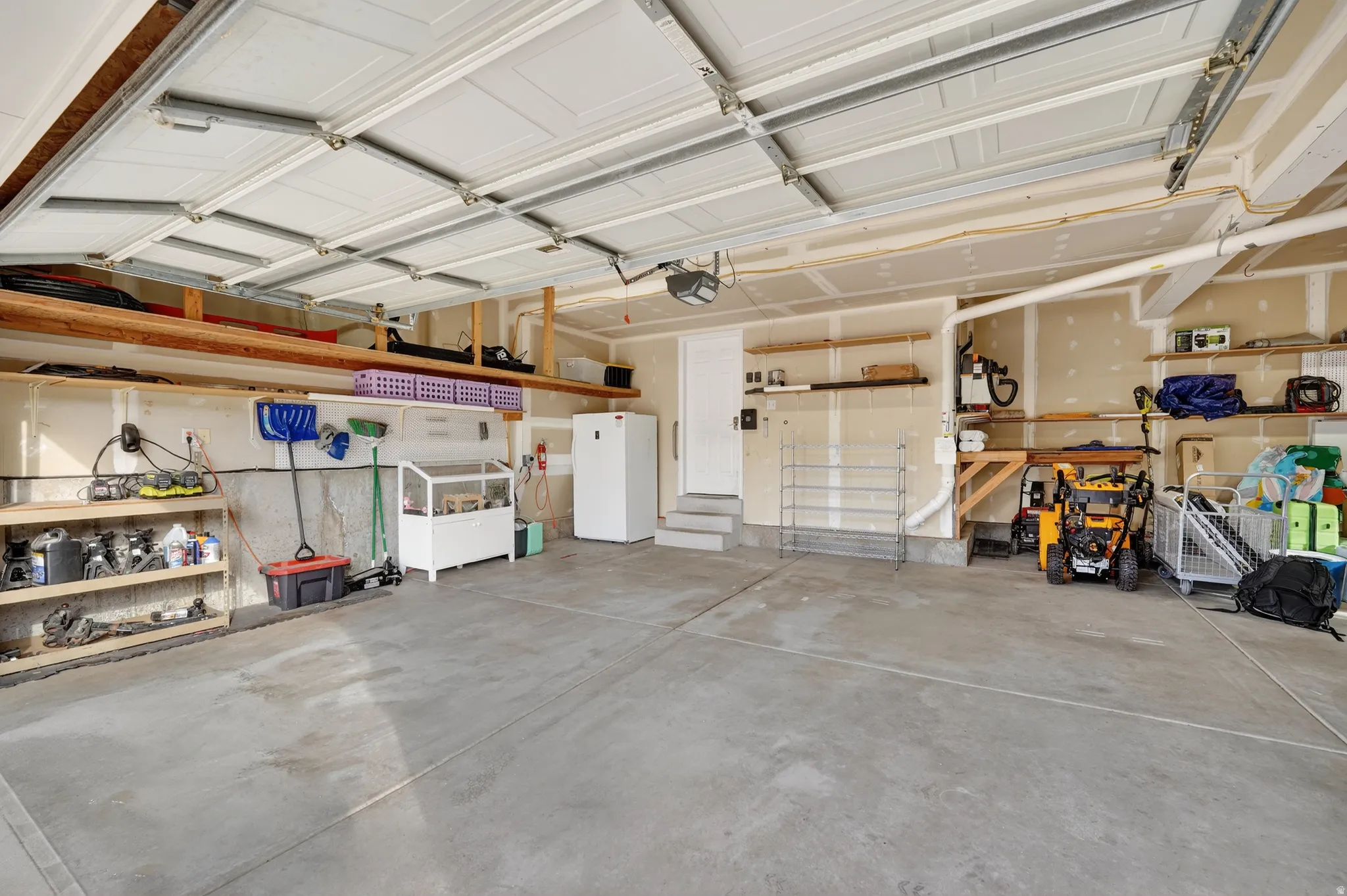 Garage featuring freestanding refrigerator