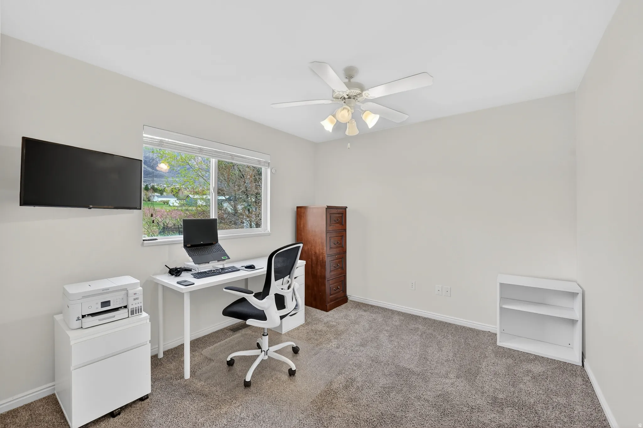 Office area featuring carpet flooring and ceiling fan