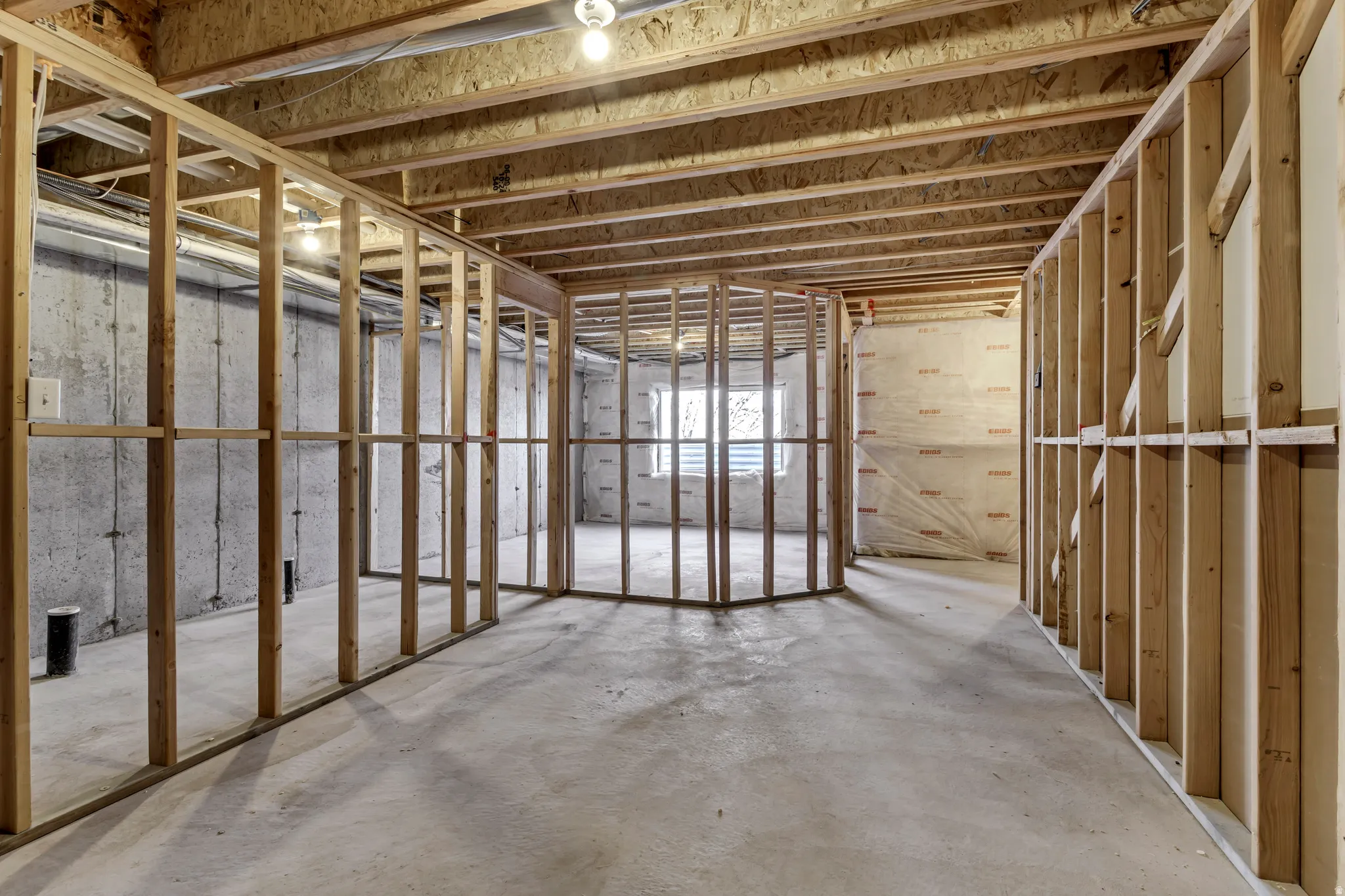 Misc room with unfinished concrete flooring