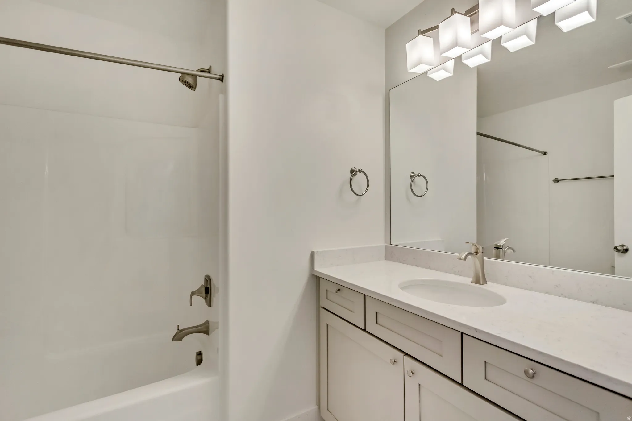 Full bath featuring vanity and shower / bath combination