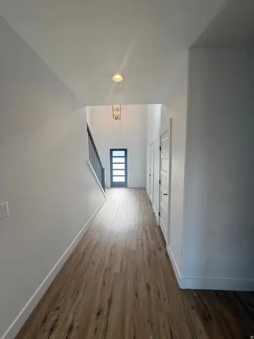 Corridor featuring dark wood-style floors and recessed lighting