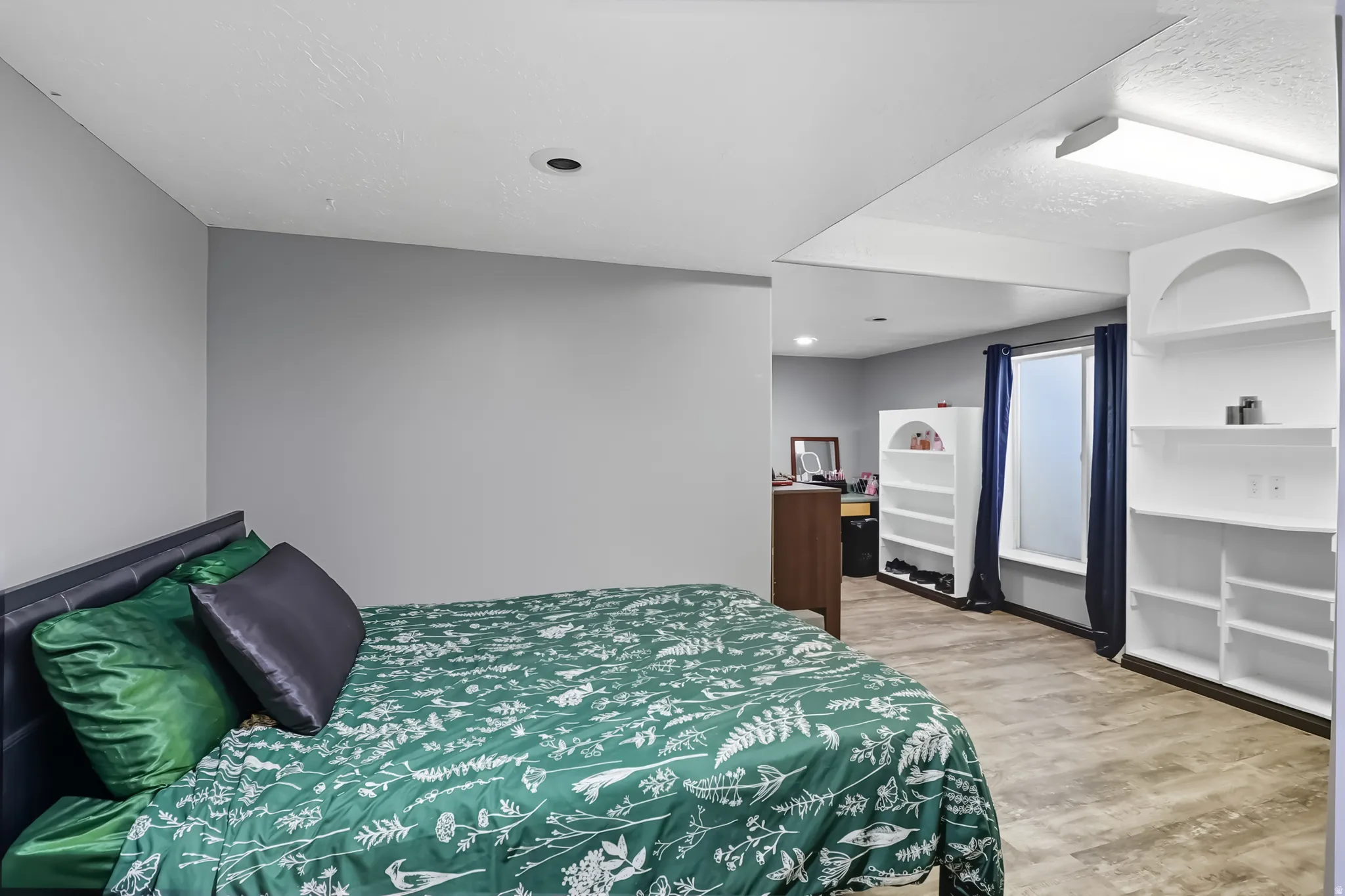 Basement bedroom with light wood-type flooring