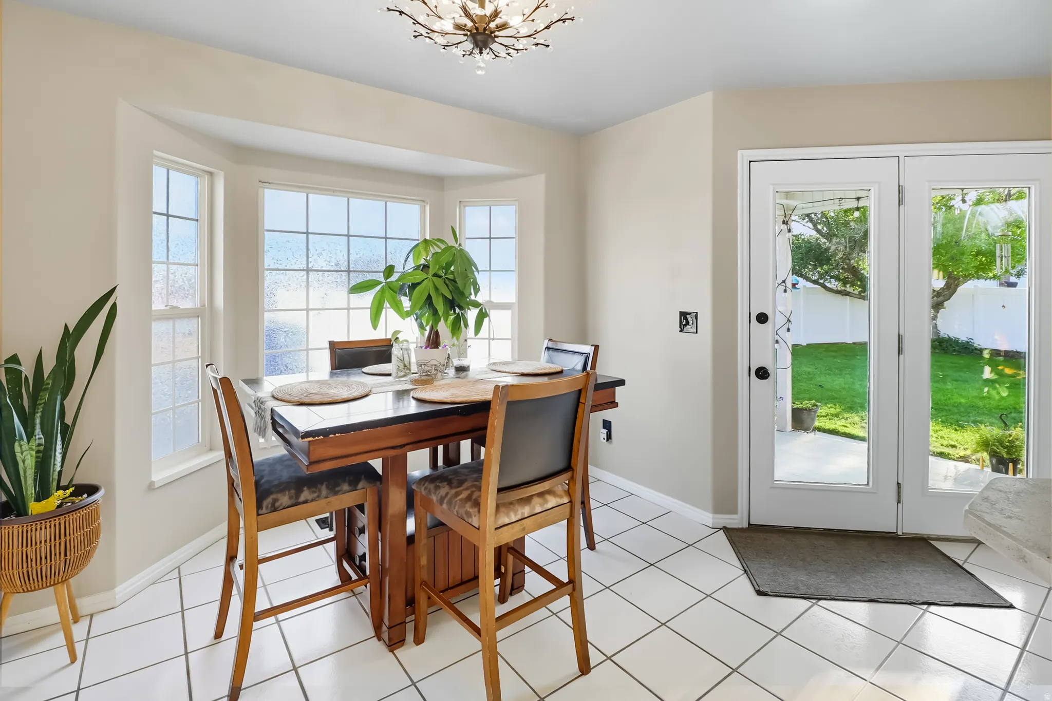 Dining space featuring light tile patterned floors and hanging lights