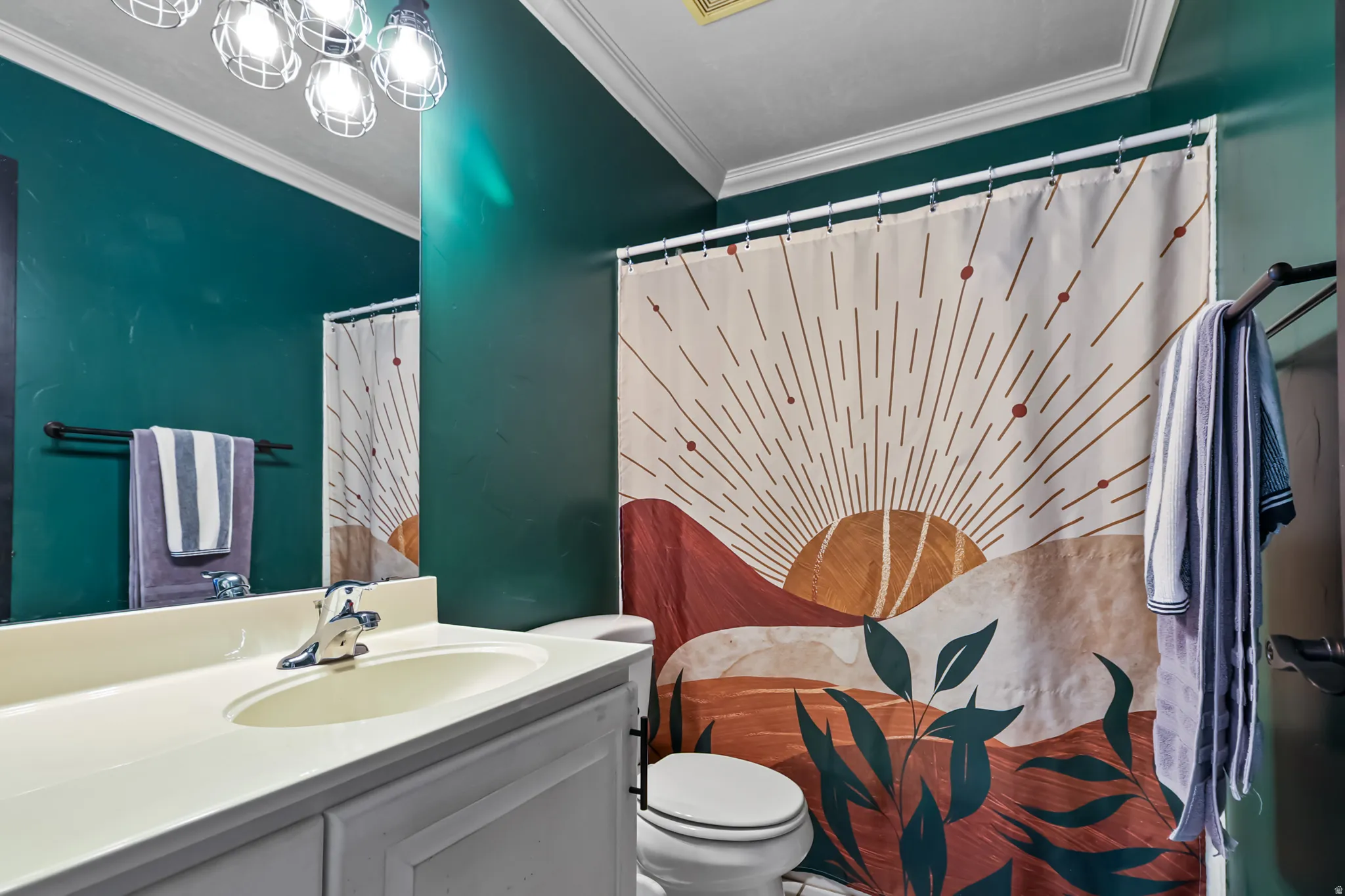 Bathroom featuring vanity, a shower with shower curtain, and ornamental molding