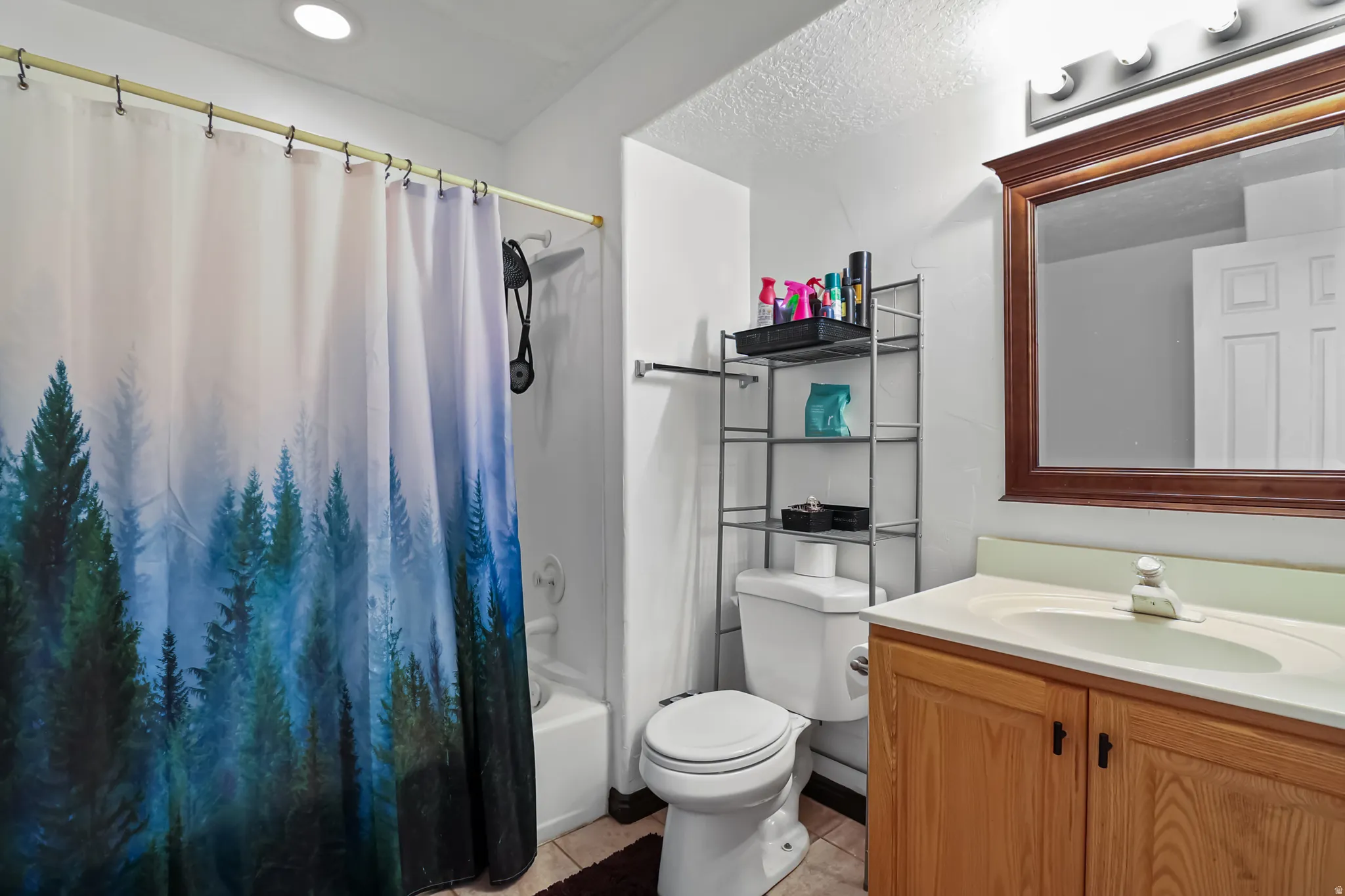 Full bathroom featuring vanity and shower / bath combination with curtain