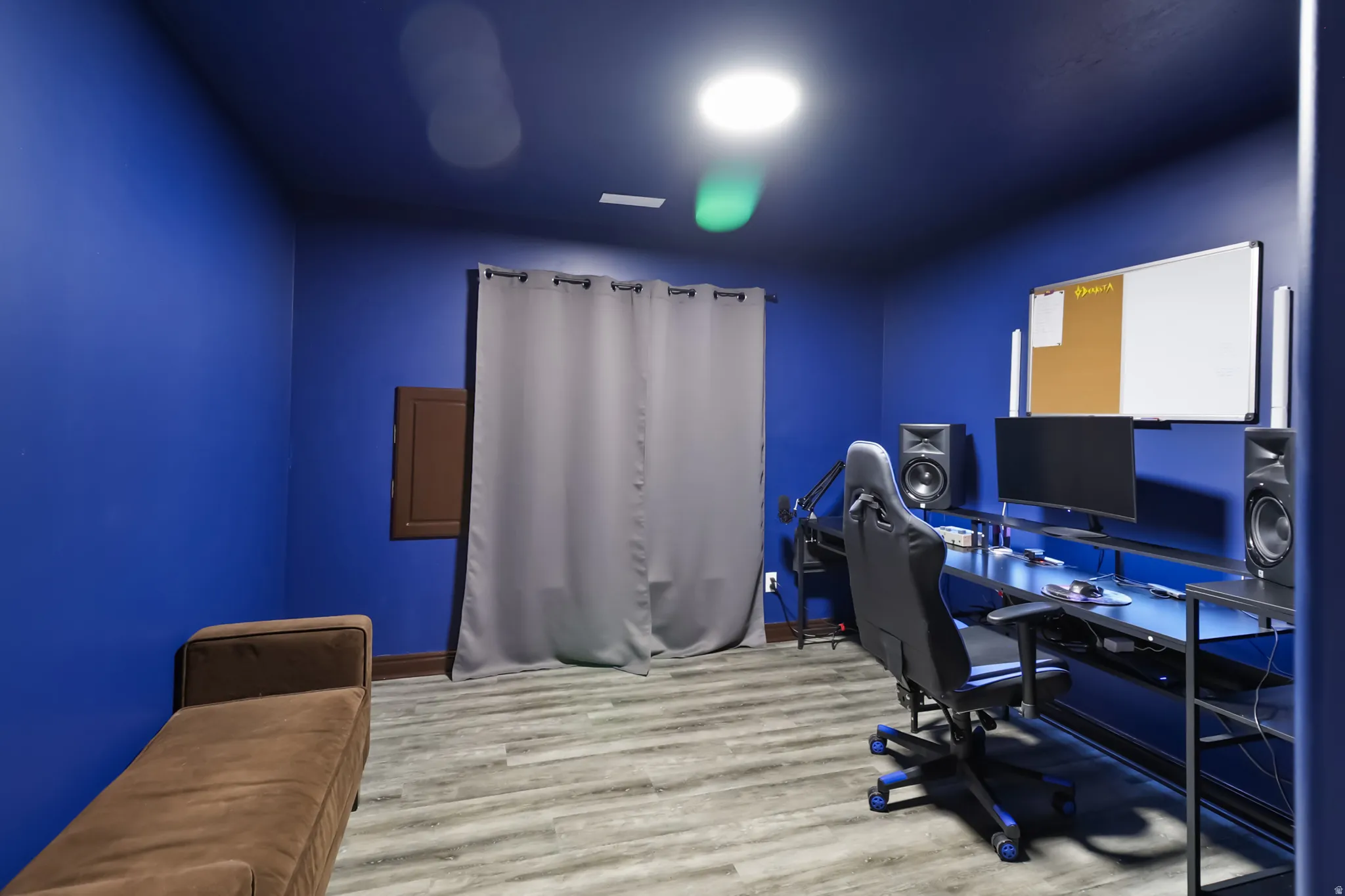 Basement office/bedroom area featuring wood finished floors and baseboards