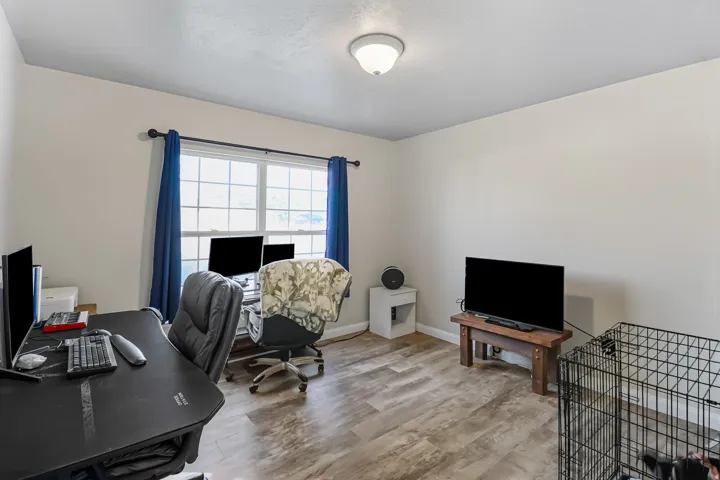 Office/Bedroom area featuring wood finished floors and baseboards
