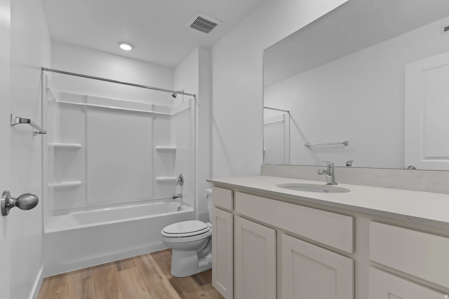 Bathroom featuring light wood-style floors, vanity, and washtub / shower combination