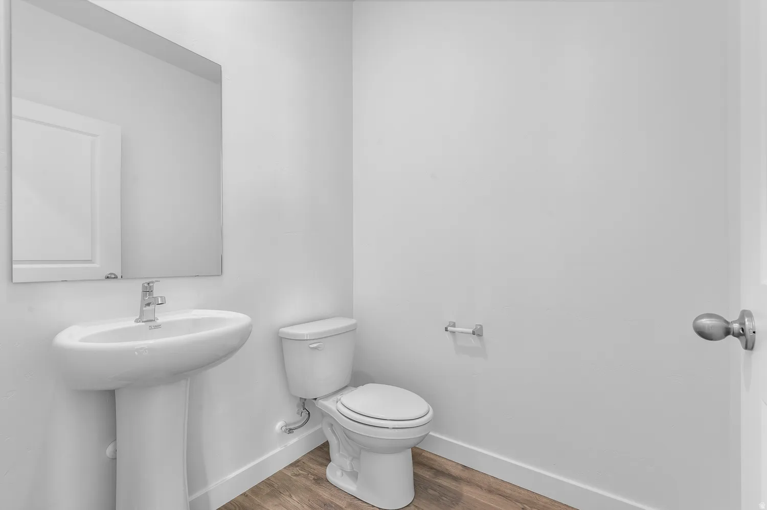 Bathroom with toilet and wood finished floors