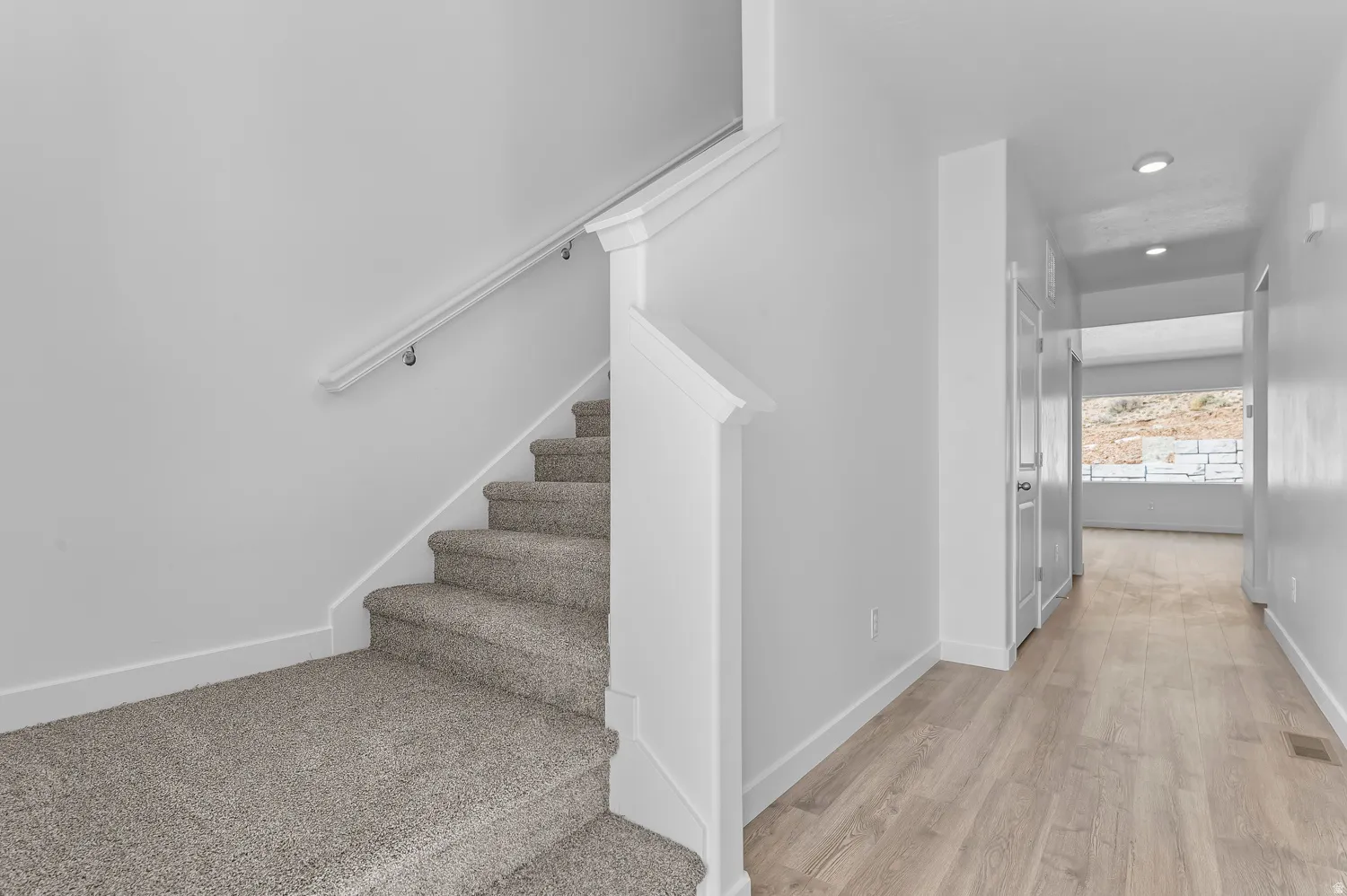 Stairs featuring wood finished floors and recessed lighting