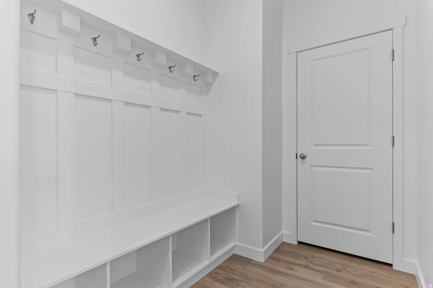 Mudroom with light wood-type flooring and baseboards