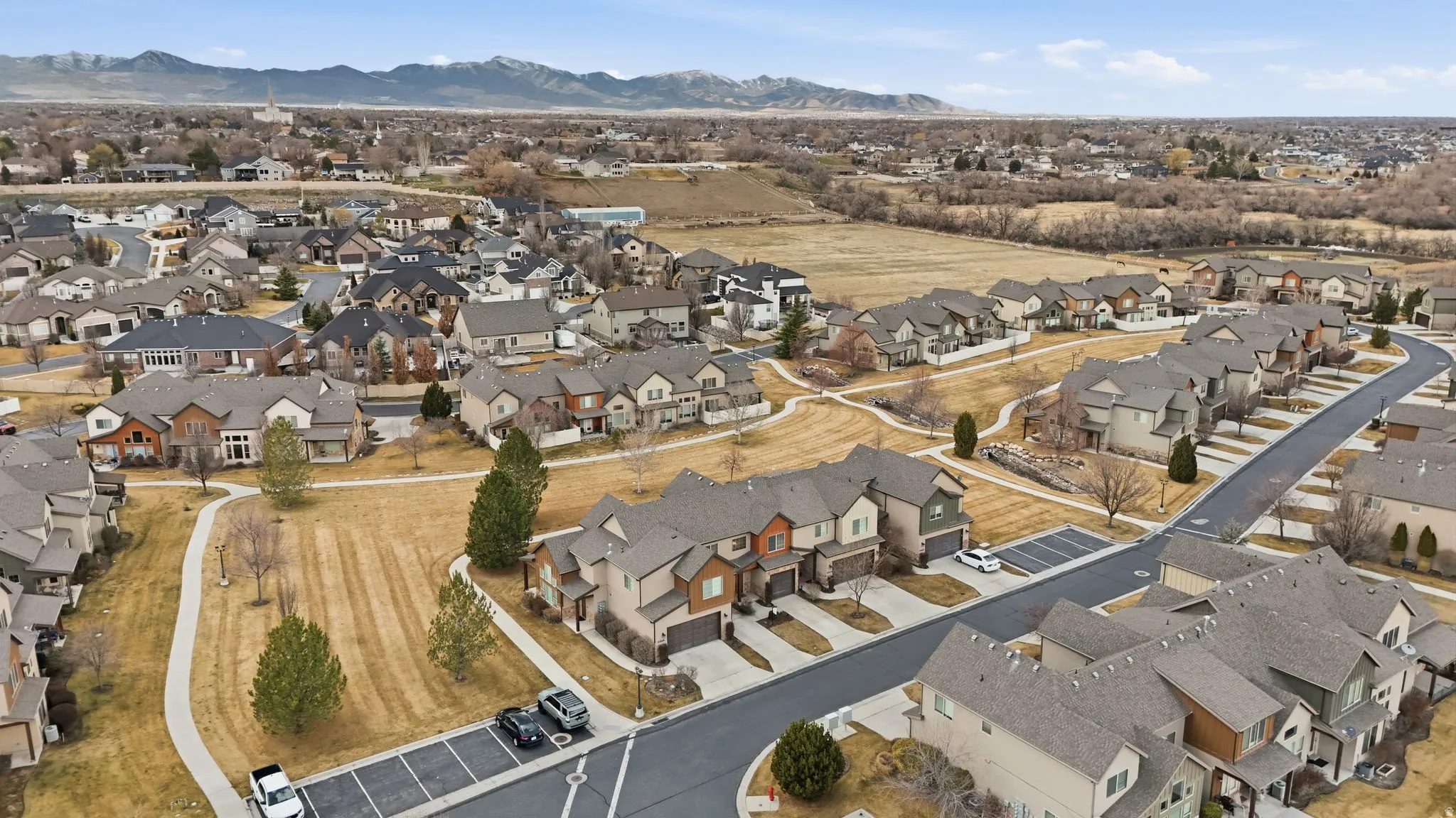 Aerial overview of property's location featuring nearby suburban area and a mountain backdrop