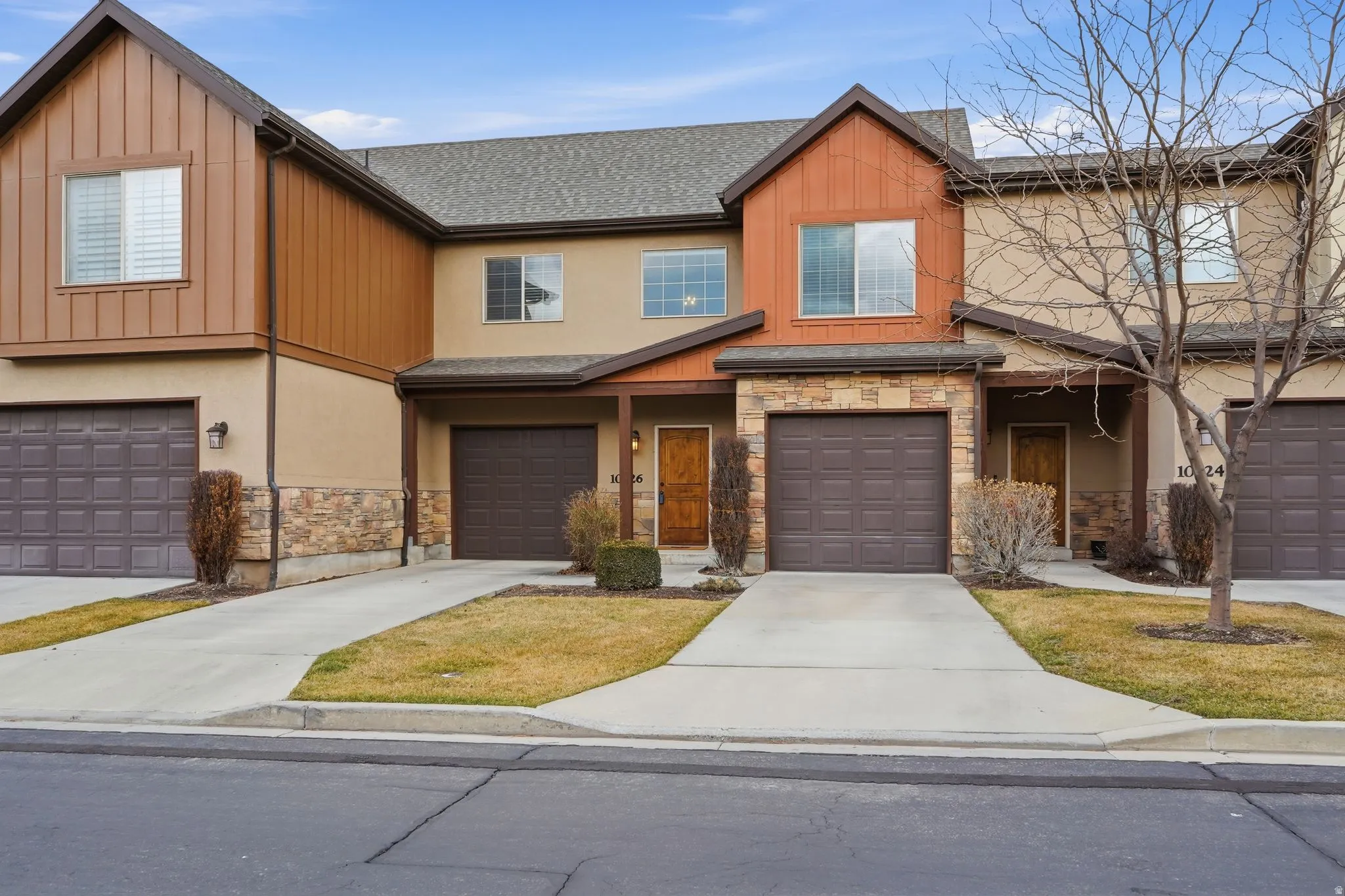 Craftsman-style house with stone siding, concrete driveway, a garage, and a shingled roof