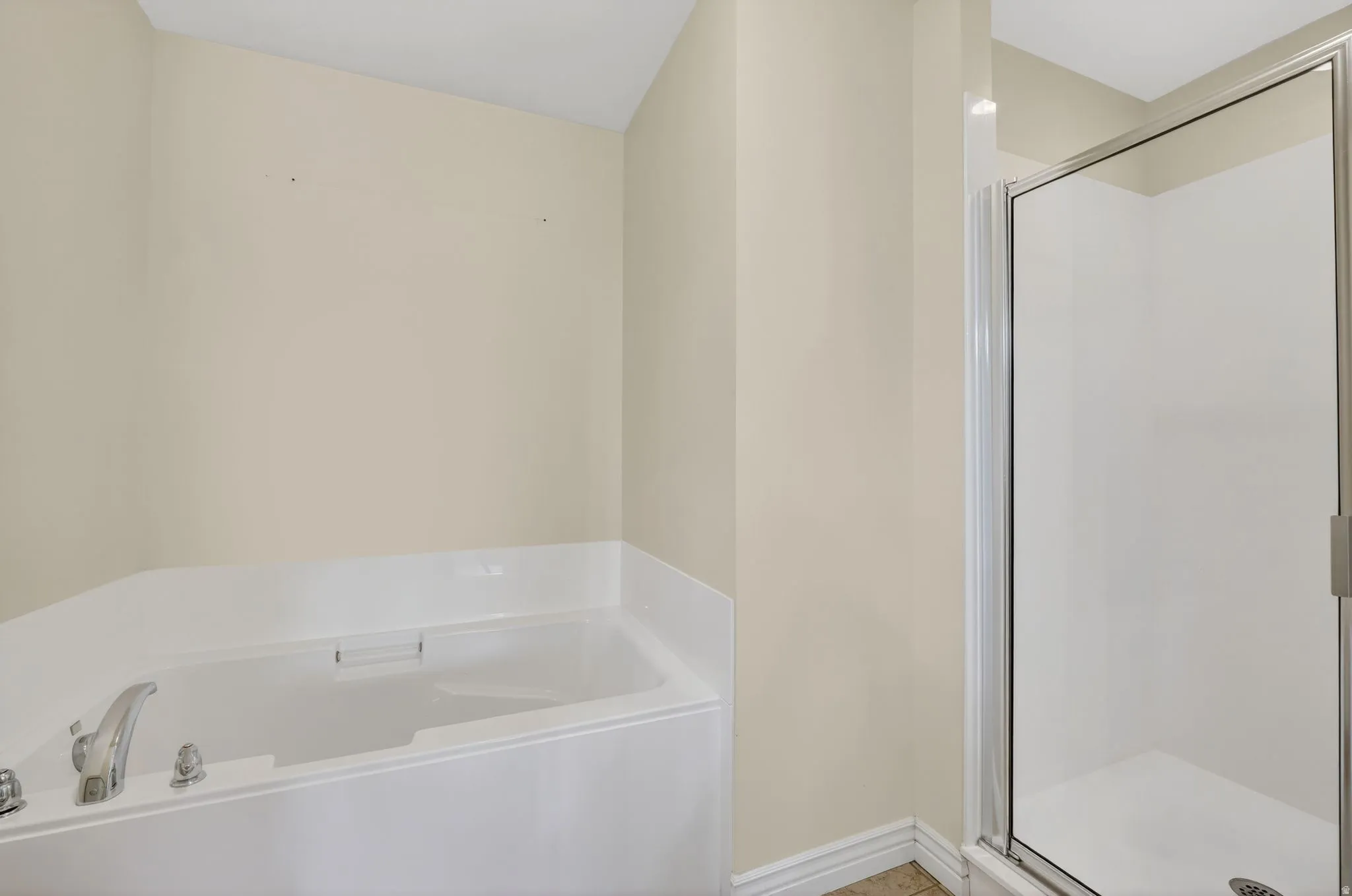 Bathroom with a bath and a shower stall