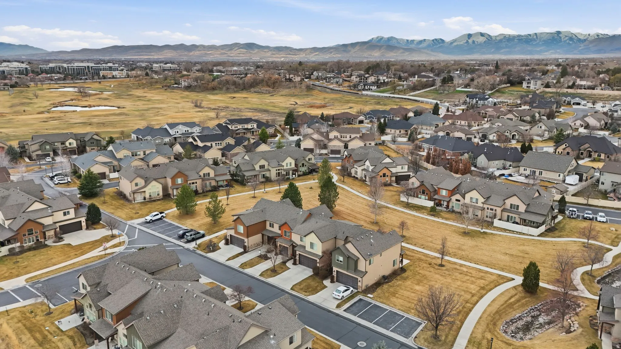 Aerial view of property's location with mountains and nearby suburban area