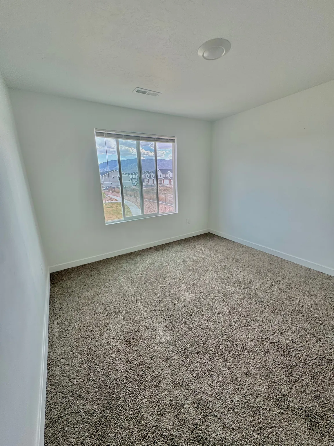 Empty room with carpet flooring and baseboards