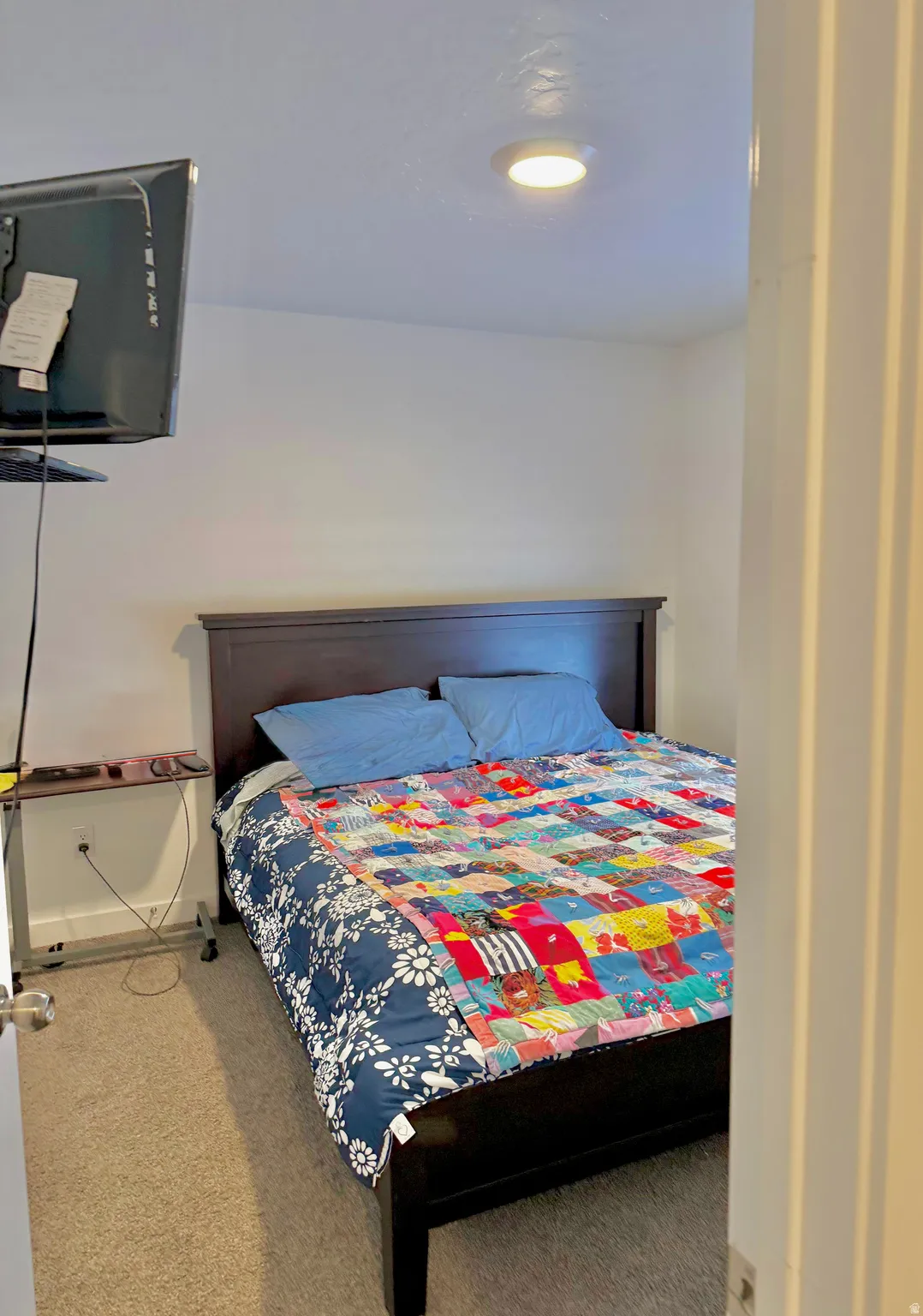Bedroom featuring light colored carpet and baseboards