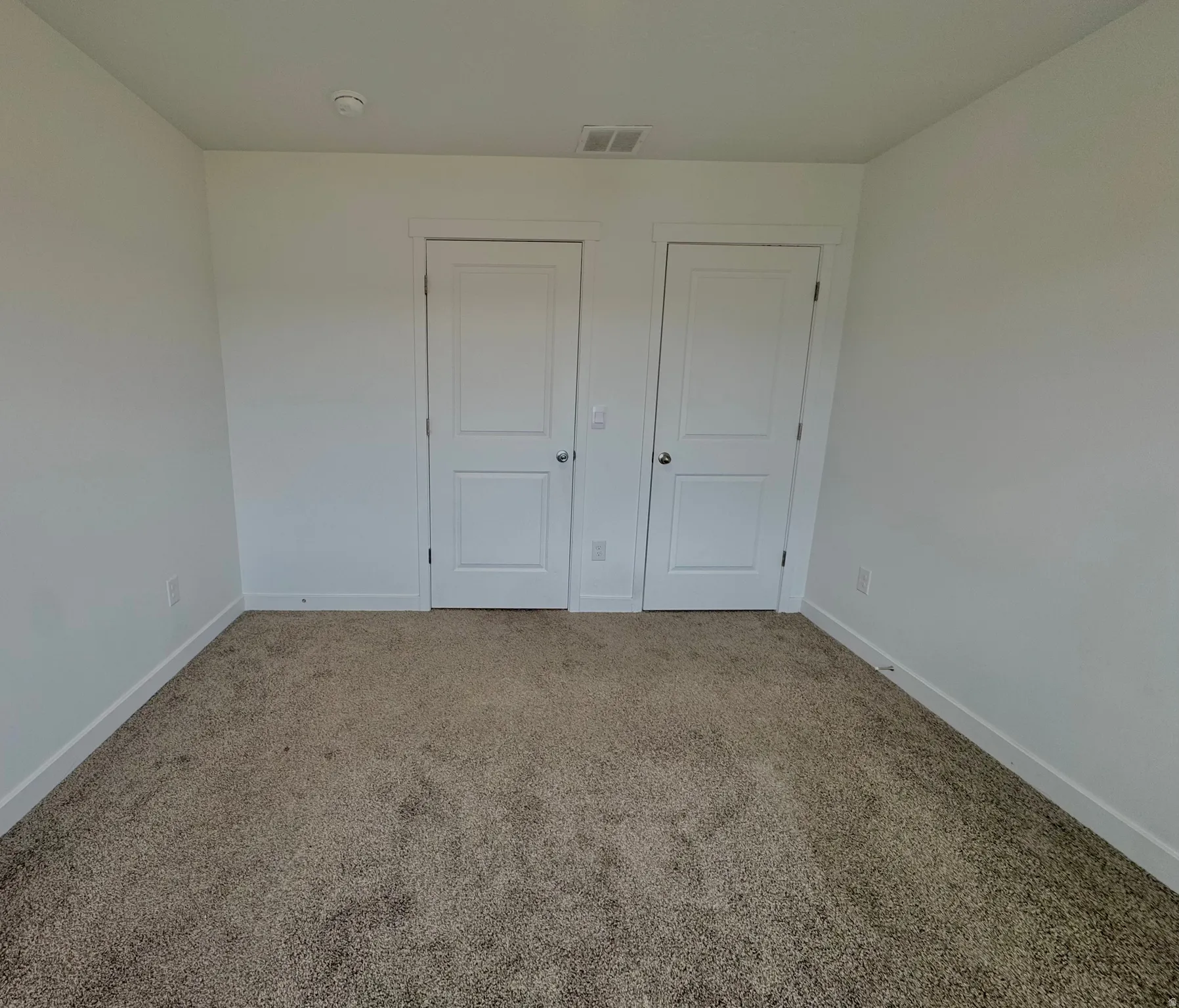Unfurnished bedroom featuring baseboards and carpet flooring