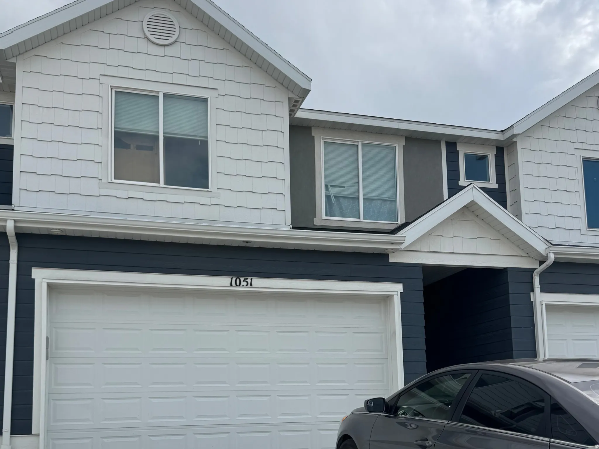 Traditional-style house with a garage and driveway