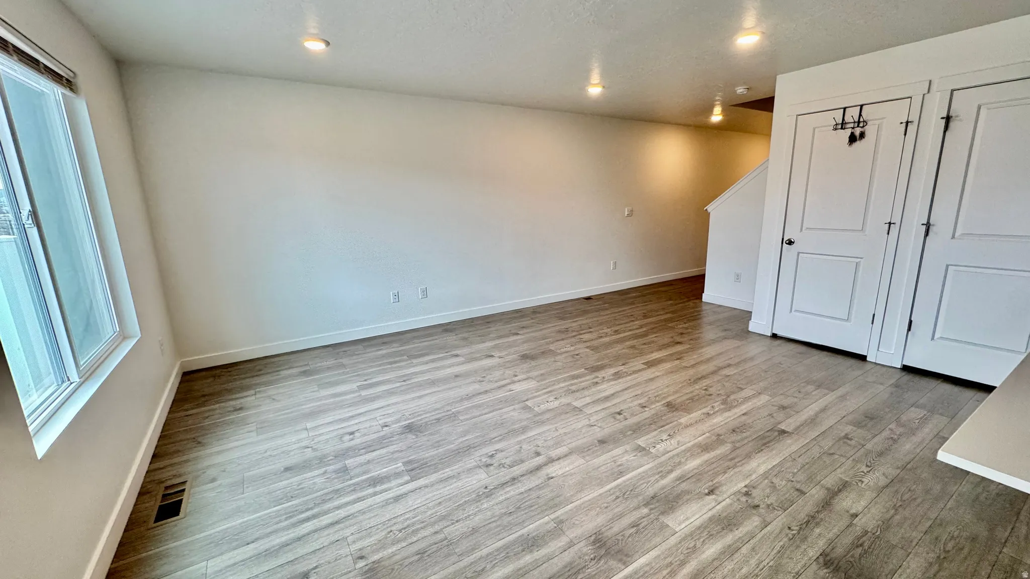 Unfurnished bedroom featuring light wood-style floors and recessed lighting