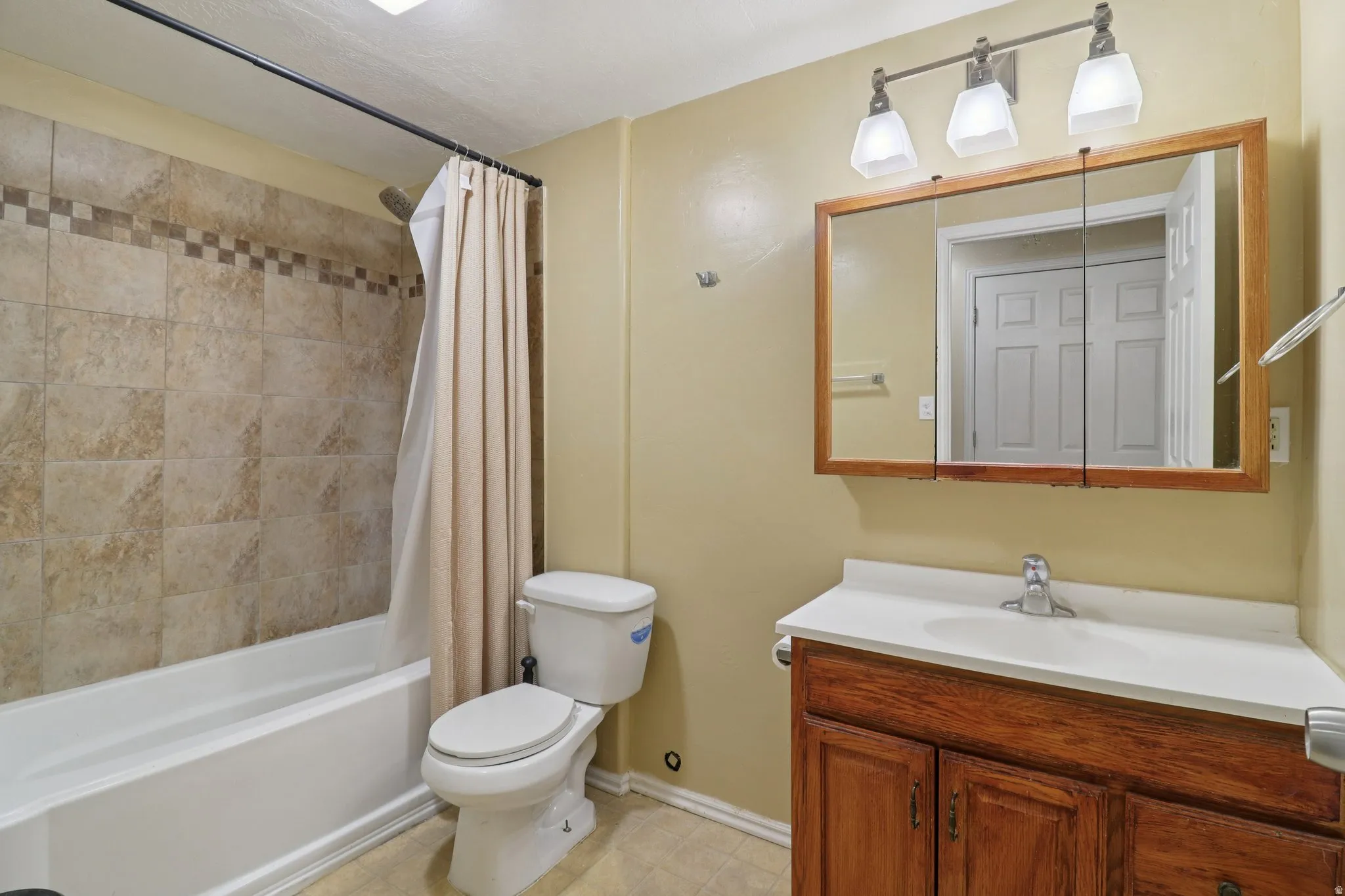 Full bath featuring vanity and shower / bath combo