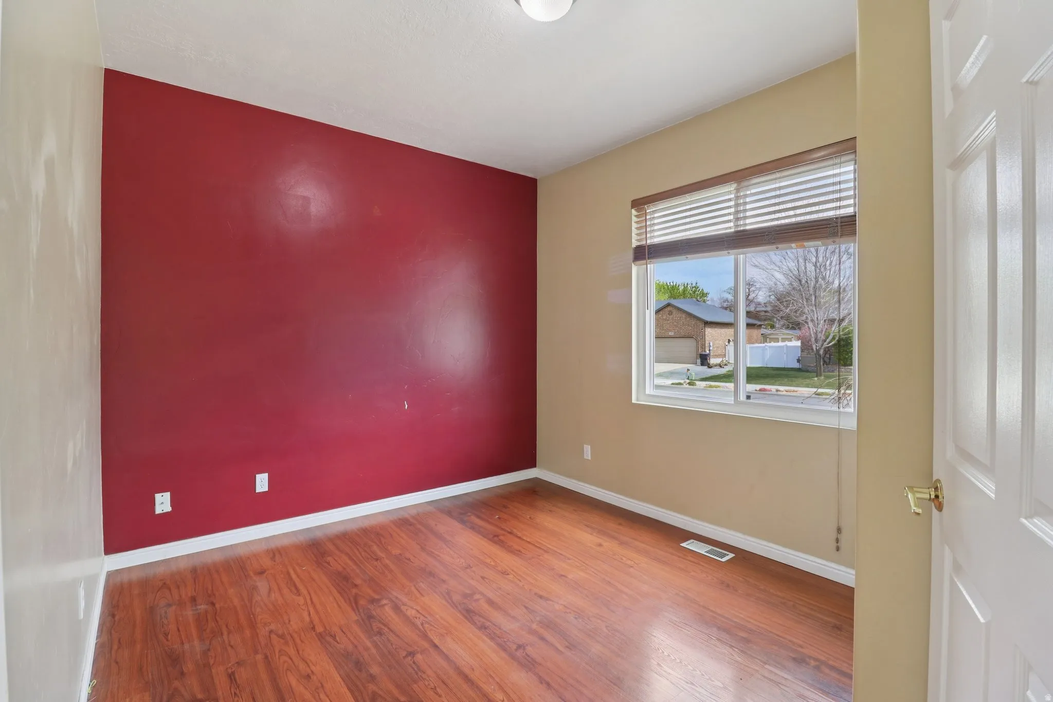 Empty room with light wood-type flooring and baseboards