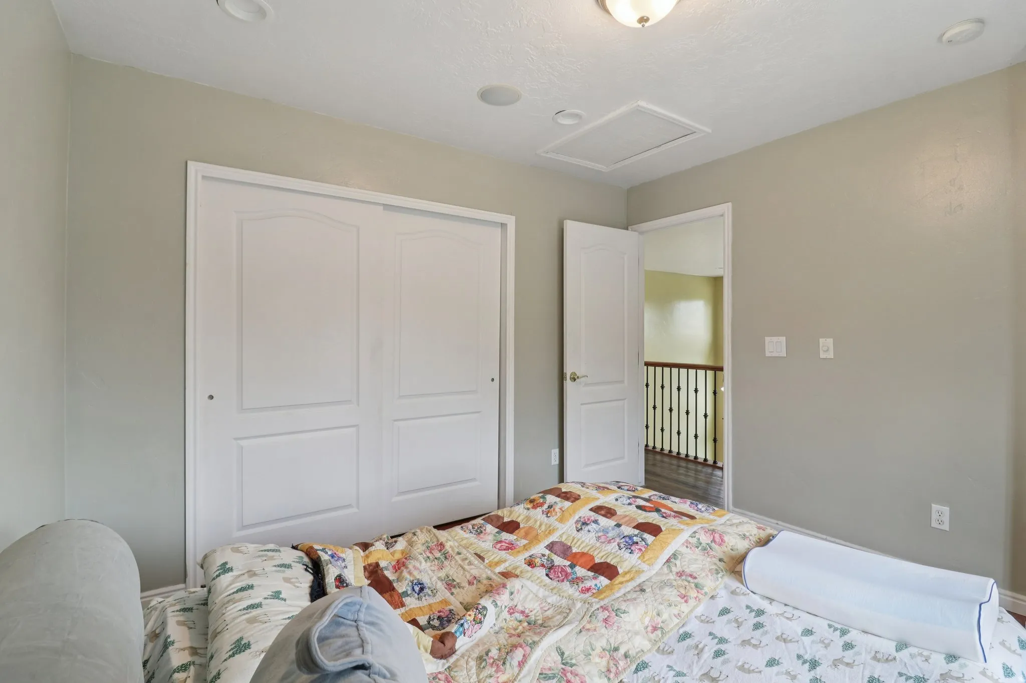 Bedroom with attic access and a closet
