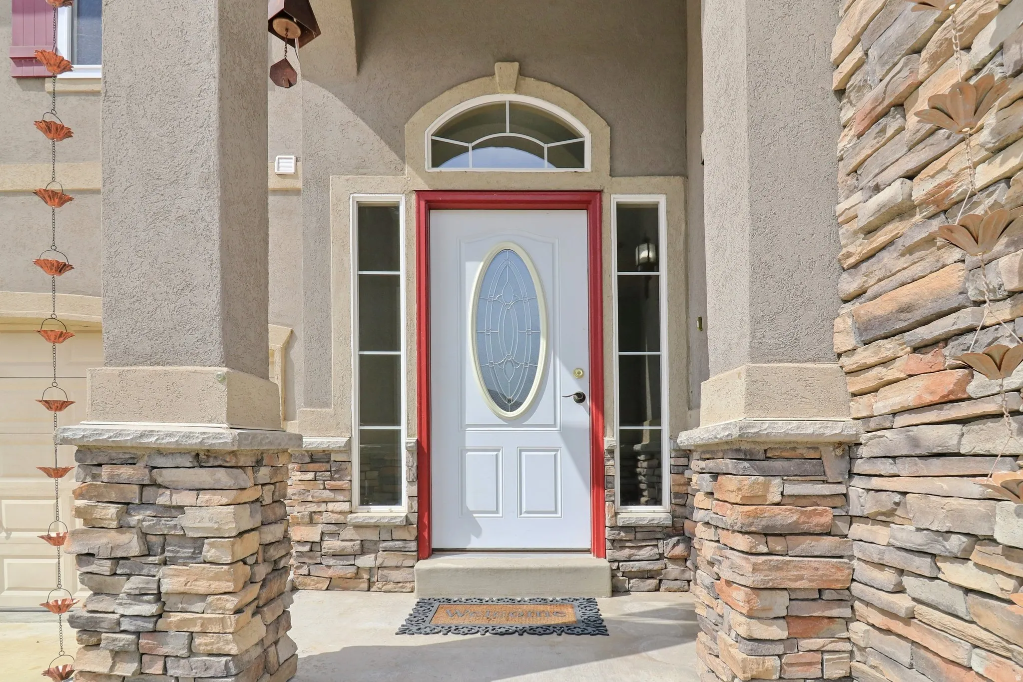 Entrance to property with stone siding and stucco siding