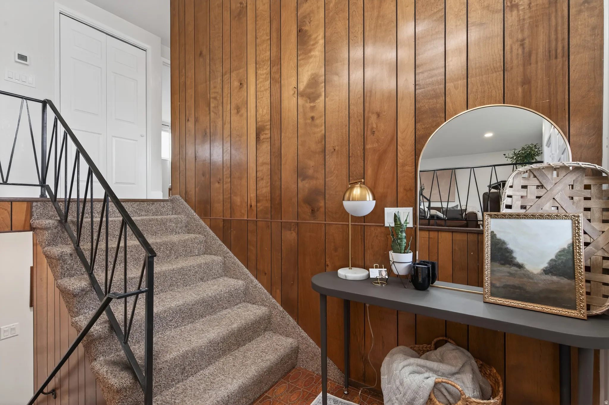 Stairs featuring wood wall