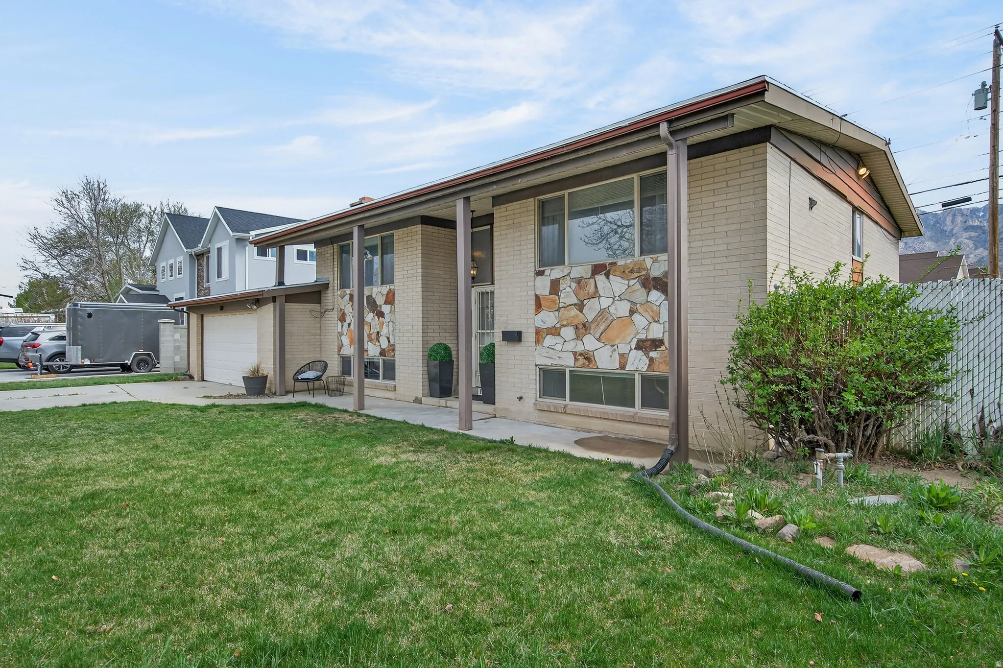 View of front facade with brick siding and concrete driveway