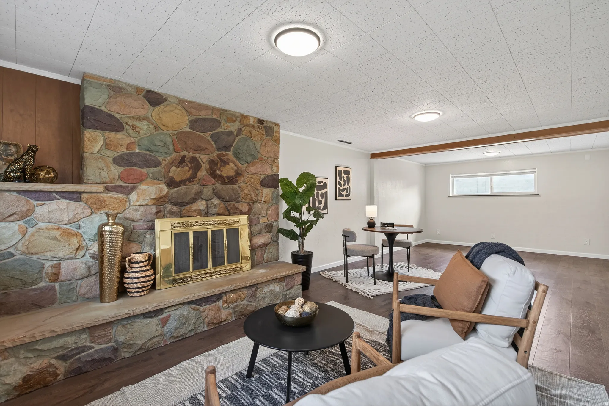 Living area with a stone fireplace and LVP floors
