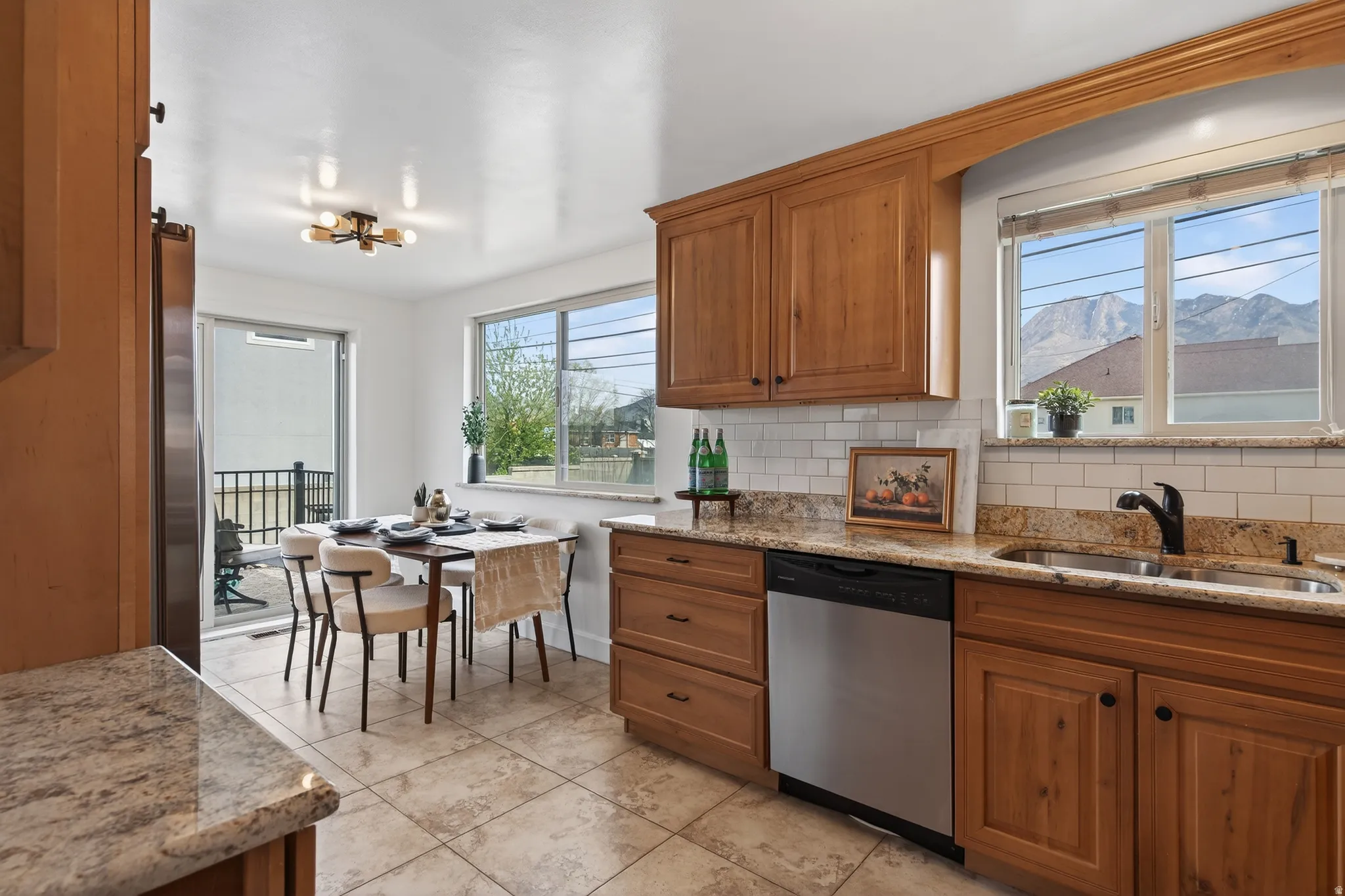 Kitchen featuring wood finish cabinetry, granite counters, stainless steel appliances, and a mountain view